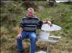 Eddie sitting on the seat erected in memory of his late grandfather - David Sinclair, who served for over 50 years on the Thurso River.